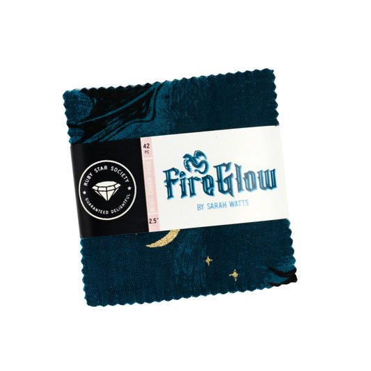 Bundle of 42 pre-cut 5-inch fabric squares from the Fireglow collection, featuring dragons, stars, and folklore-inspired prints in vibrant jewel tones and warm glowing colors.
