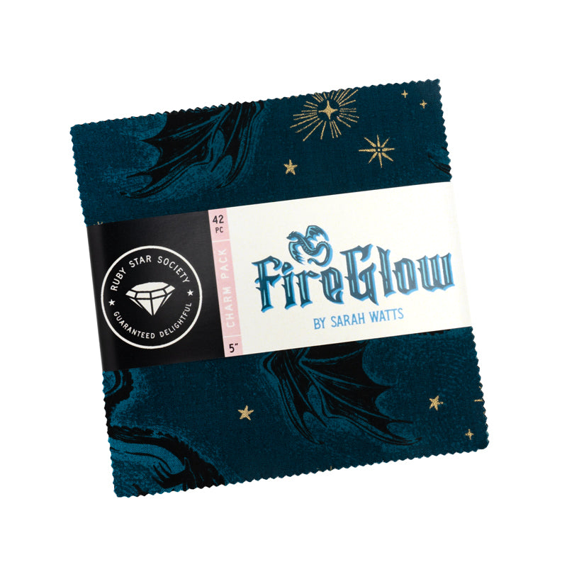 Bundle of 42 pre-cut 5-inch fabric squares from the Fireglow collection, featuring dragons, stars, and folklore-inspired prints in vibrant jewel tones and warm glowing colors.