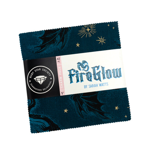 Bundle of 42 pre-cut 5-inch fabric squares from the Fireglow collection, featuring dragons, stars, and folklore-inspired prints in vibrant jewel tones and warm glowing colors.